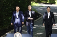 South Korean President Yoon Suk-yeol, U.S. President Joe Biden and Prime Minister Fumio Kishida arrive for a news conference during a trilateral summit at Camp David, Maryland, in the United States on Aug. 18. The three countries drew closer in 2023 amid growing concerns over North Korea and China. | Bloomberg