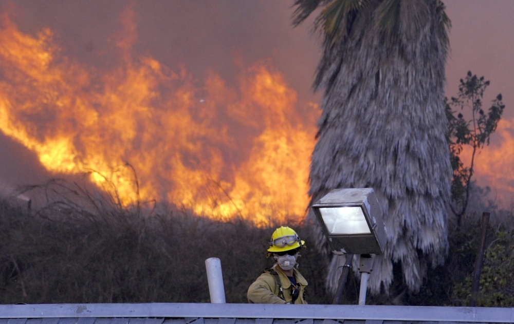 Firefighters work to contain a wildfire in Malibu, California.