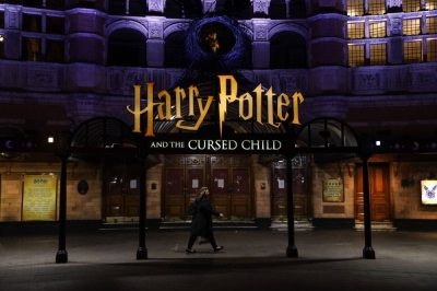 A pedestrian walks past a theatre promoting the "Harry Potter and the Cursed Child" show in the West End district of London in 2020.