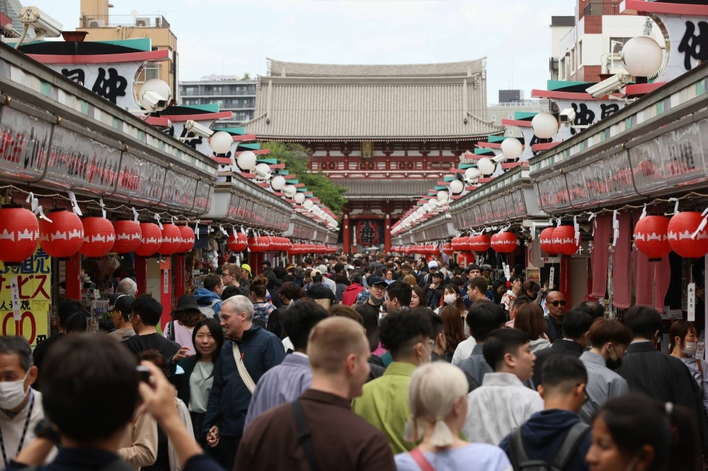 The Nakamise-dori shopping street in Tokyo’s Asakusa district. Foreign tourists returned in droves in 2023, spurring fresh concerns of overtourism. The influx of visitors came after Japan downgraded the status of COVID-19 to a lower-risk disease category, effectively ending all pandemic-related restrictions. 
