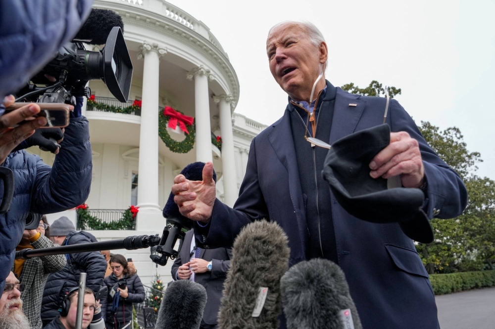 U.S. President Joe Biden answers reporters questions as he departs for Camp David from the South Lawn at the White House in Washington on Dec. 23. 