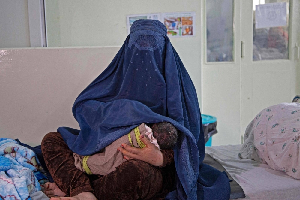 An Afghan woman holds her newborn child at a maternity hospital in Khost, Afghanistan. According to the latest World Health Organization figures, from 2017, 638 women die in Afghanistan for every 100,000 viable births, compared with 19 in the United States.