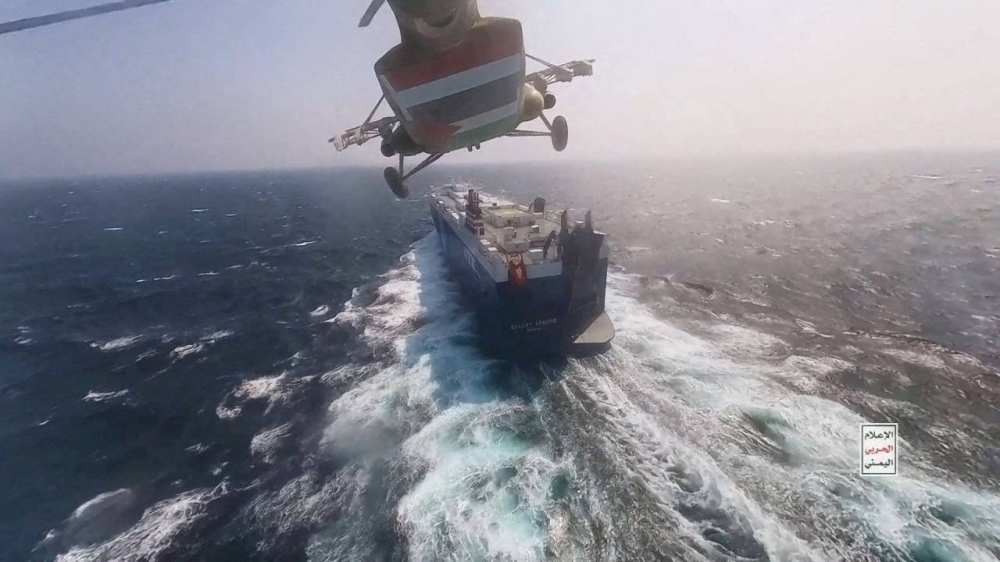A Houthi military helicopter flies over the Galaxy Leader cargo ship in the Red Sea in this photo released on Nov. 20.