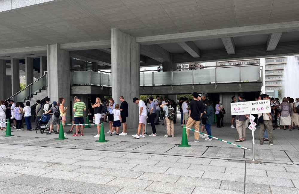 People line up to enter the Hiroshima Peace Memorial Museum in the city of Hiroshima on Aug. 14.