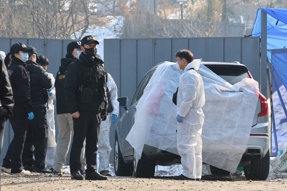 Police officers examine a scene where South Korean actor Lee Sun-kyun was found dead at a park in Seoul on Wednesday.