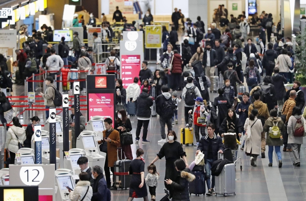 Passengers fill the departure lobby for domestic flights at Haneda Airport in Tokyo on Friday.