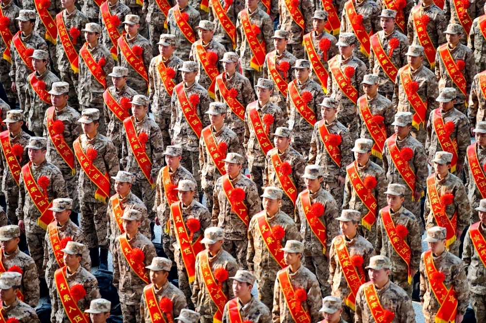 New recruits for the People's Liberation Army attend a ceremony at a railway station in Ganzhou, in China's Jiangxi province, in March. 