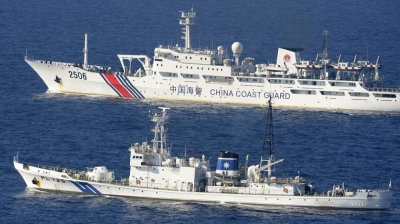 A Chinese coast guard ship and a vessel of the Japan Coast Guard sail in close proximity to each other, near the Senkaku Islands in 2013. 