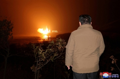 North Korean leader Kim Jong Un looks on as a rocket carrying a spy satellite is launched in November.