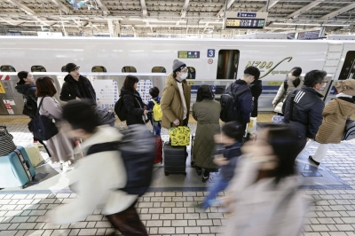 A line of travelers on a shinkansen platform at JR Tokyo Station on Friday