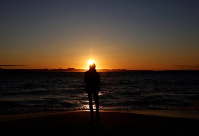 A person looks at the first sunrise of the year on the beach in Miura, Kanagawa Prefecture, on Monday.