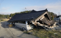 A house is seen collapsed in the town of Shika on Tuesday. | KYODO