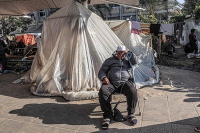 A man dozes while leaning on a crutch as he sits outside a tent where displaced Palestinians are camped in the southern Gaza Strip on Sunday.