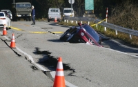 A vehicle in a collapsed portion of a road in Anamizu, Ishikawa Prefecture, on Tuesday  | Kyodo