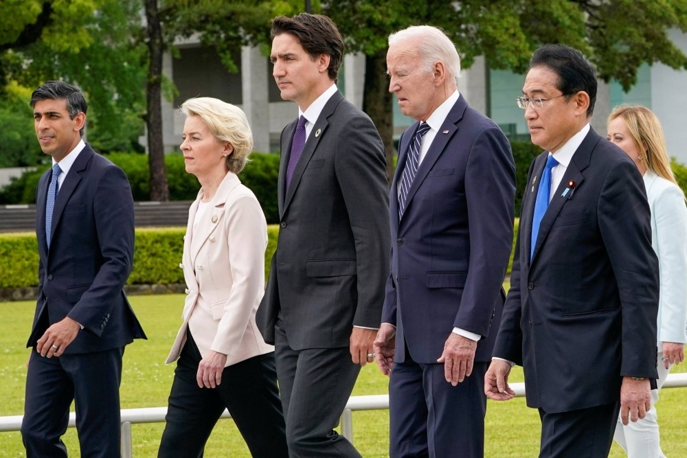 From left: British Prime Minister Rishi Sunak, European Commission President Ursula von der Leyen, Canadian Prime Minister Justin Trudeau, U.S. President Joe Biden and Japan's Prime Minister Fumio Kishida walk to a flower wreath laying ceremony at the Peace Memorial Park in Hiroshima in May during the G7 Summit.