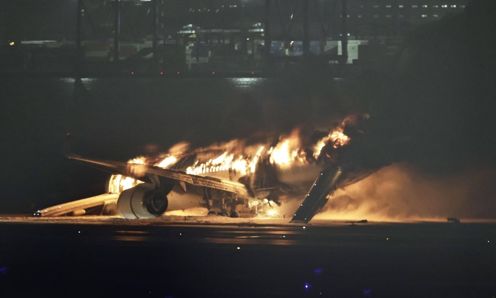 A Japan Airlines plane burning at Tokyo's Haneda Airport on Tuesday evening