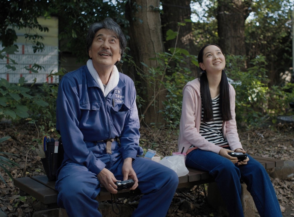A Tokyo toilet cleaner (Koji Yakusho, left) bonds with his teenage niece (Arisa Nakano) in “Perfect Days.”