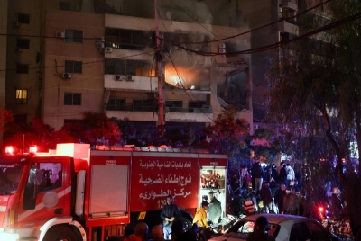 People gather at the site of an explosion in what security sources say is an Israeli drone strike in the Beirut suburb of Dahiyeh, Lebanon, on Tuesday.