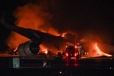 A Japan Airlines (JAL) passenger plane burns on the tarmac at Tokyo's Haneda Airport on Tuesday.