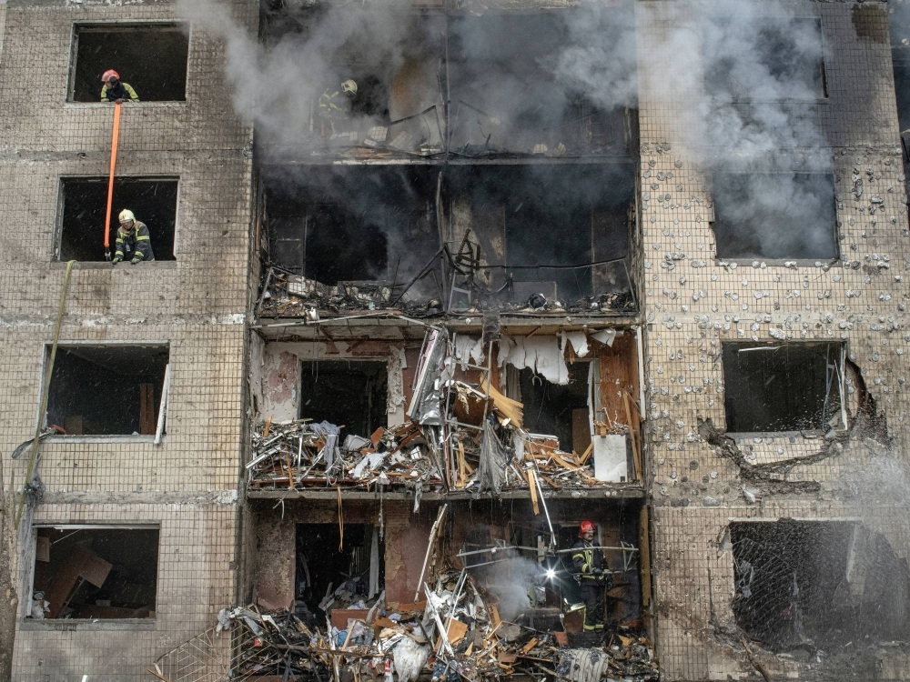 Firefighters and first responders inside a residential building that was hit by a Russian missile strike in Kyiv on Tuesday. 