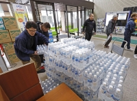 Water bottles being prepared for delivery from Nanao city hall, Ishikawa Prefecture, where a major quake hit, on Wednesday. | KYODO