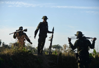 Members of the People's Defence Forces who became guerrilla fighters after being protesters are seen on the front line in Kawkareik, Myanmar, in December 2021.