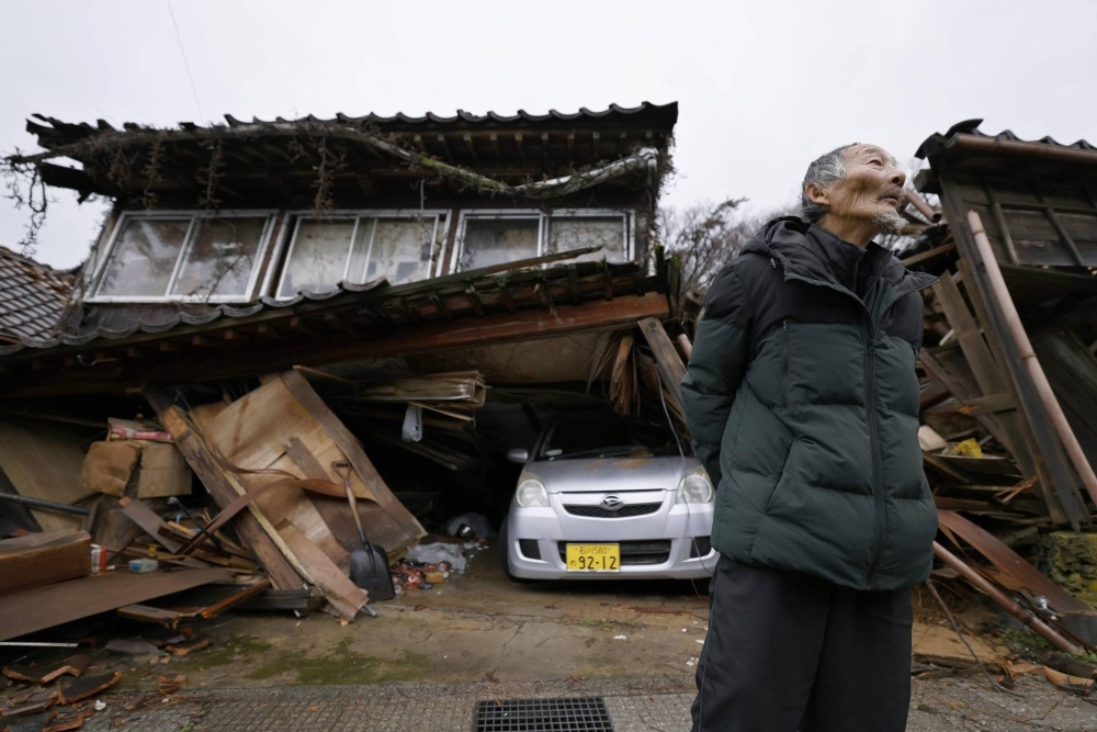 Kazuo Okawa, 75, in front of his collapsed house in Shika, Ishikawa Prefecture. 