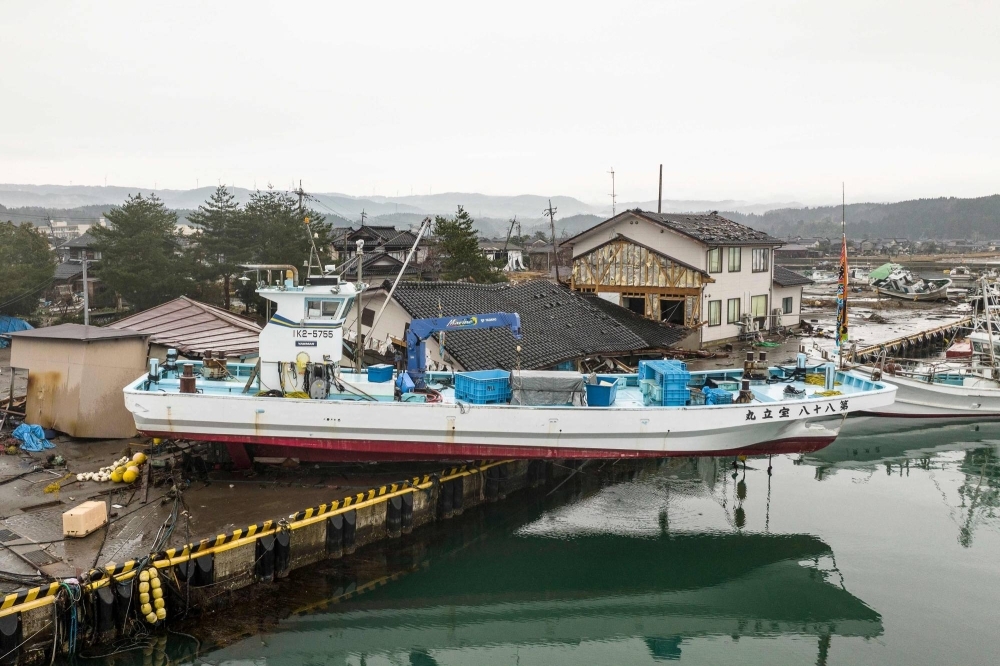 A ship washed ashore is pictured in Suzu, Ishikawa Prefecture