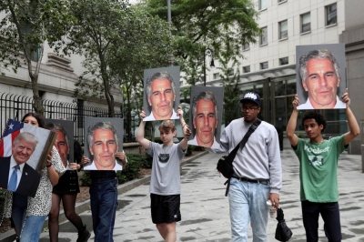 Demonstrators hold signs protesting Jeffrey Epstein as he awaits arraignment in the Southern District of New York on charges of sex trafficking of minors in 2019. While Epstein died by suicide that same year in a Manhattan prison cell before he could stand trial, his crimes have continued to resonate across Wall Street.