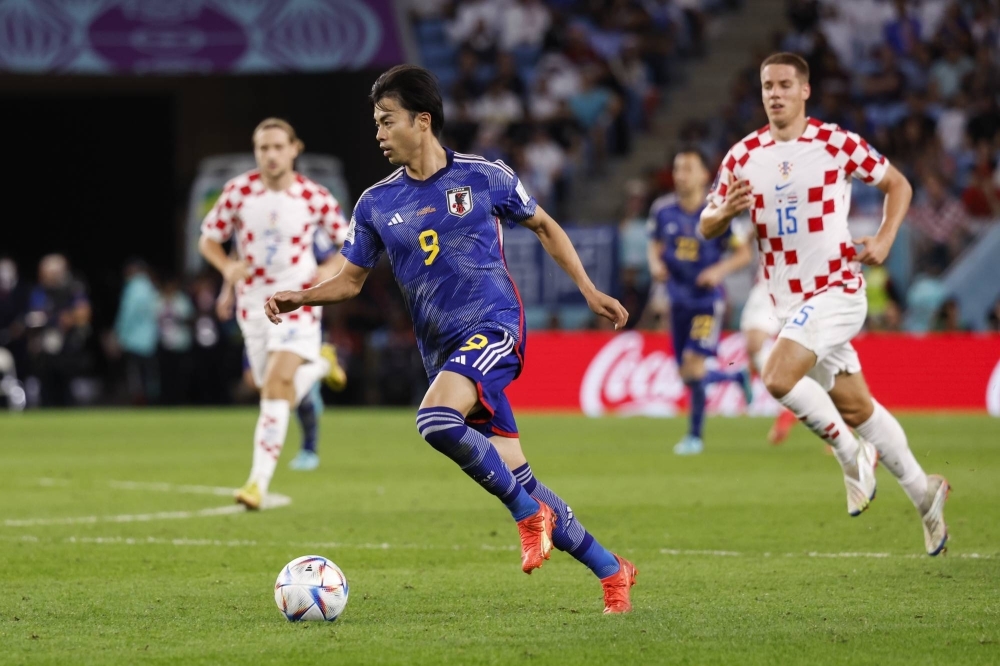 Japan midfielder Kaoru Mitoma controls the ball during extra time of the team's Round of 16 match against Croatia at the 2022 World Cup in Qatar. Mitoma was named to the Samurai Blue squad for the upcoming Asian Cup despite an ankle injury. 