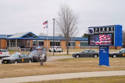 Police vehicles are parked outside the Perry Middle School and High School complex following a school shooting, in Perry, Iowa, on Thursday.
