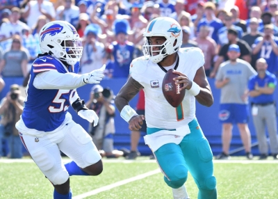Miami Dolphins quarterback Tua Tagovailoa is chased out of the pocket by Buffalo Bills defensive end Kingsley Jonathan during a game in Buffalo in October. 