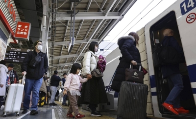 Passengers board a JR bullet train at Shin-Osaka Station on Wednesday.