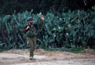 An Israeli soldier walks on the Israeli side of the border with the Gaza Strip, amid the ongoing conflict between Israel and the Palestinian Islamist group Hamas, on Saturday.