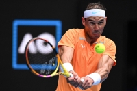 Rafael Nadal hits a return during a match at the Australian Open in January 2023.  | AFP-JIJI