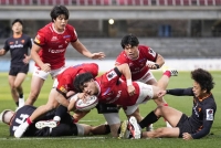 Brave Lupus Tokyo's Masaki Hamada (center) crosses for a try in a Japan Rugby League One game against Kubota Spears at Kawasaki's Todoroki Stadium on Sunday. | Kyodo