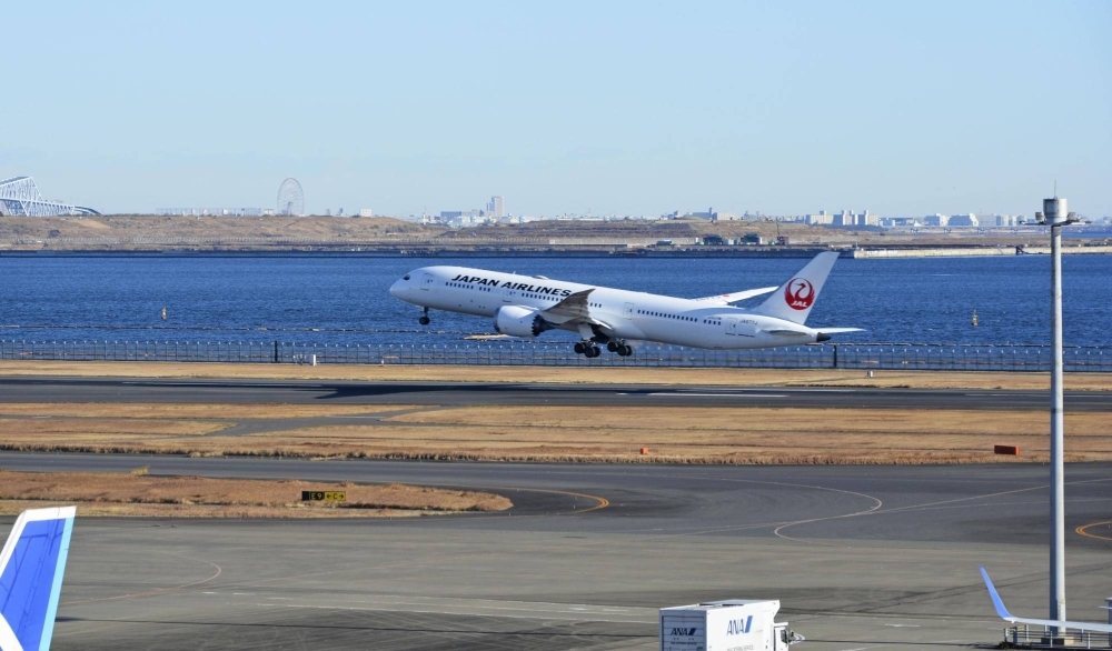 A Japan Airlines plane takes off from the reopened Runway C at Tokyo's Haneda Airport on Monday.