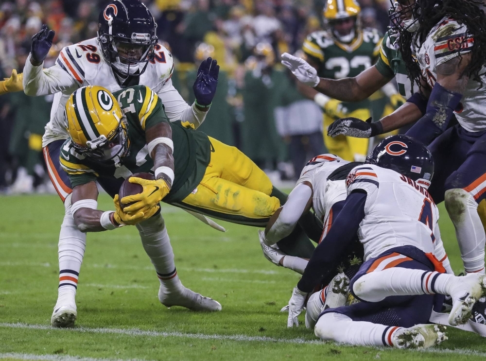 Green Bay Packers wide receiver Dontayvion Wicks dives into the end zone to score a touchdown against the Chicago Bears in Green Bay, Wisconsin, on Sunday. A win over Chicago earned Green Bay the final NFL playoff spot.