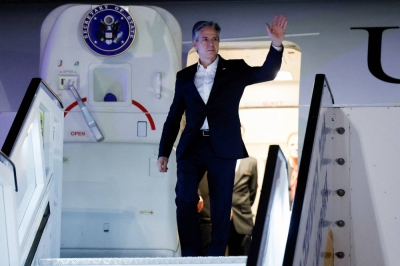 U.S. Secretary of State Antony Blinken gestures as he arrives in Tel Aviv on Monday as part of his weeklong trip aimed at calming tensions across the Middle East.
