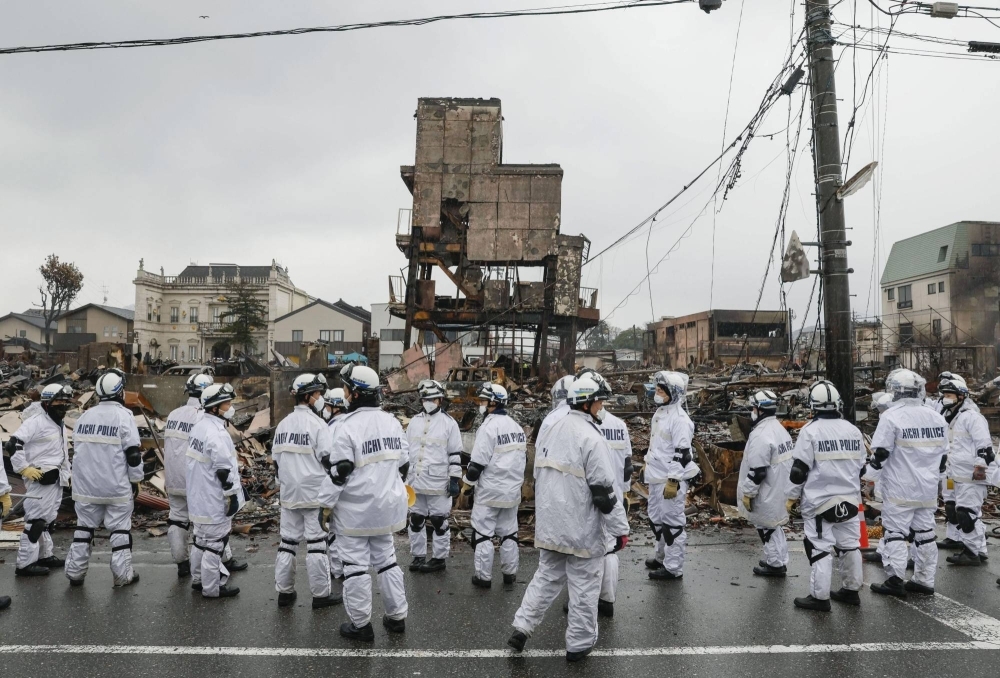 Police gather for a large-scale search at the Wajima Morning Market, which was destroyed by fire following the New Year's Day earthquake, in Wajima, Ishikawa Prefecture, on Wednesday.