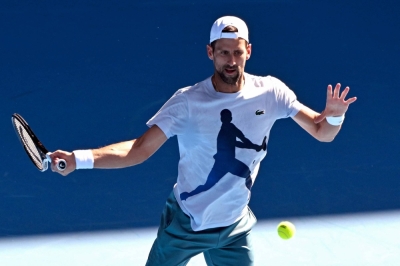 Serbia's Novak Djokovic hits a return during a practice session ahead of the Australian Open, in Melbourne on Tuesday, 