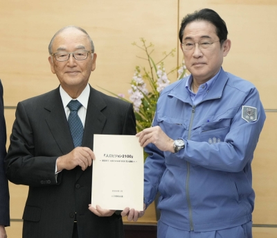 Akio Mimura, honorary chairman of Nippon Steel and head of a private panel focused on depopulation, submits the group's proposal to Prime Minister Fumio Kishida in Tokyo on Tuesday.