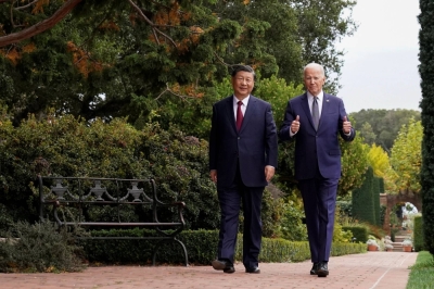 U.S. President Joe Biden gives a thumbs-up as he walks with Chinese leader Xi Jinping at Filoli estate on the sidelines of the Asia-Pacific Economic Cooperation summit, in Woodside, California, on Nov. 15. Their meeting attempted to calm the waters and tried to convey a sense that the U.S. and China could effectively manage their differences.