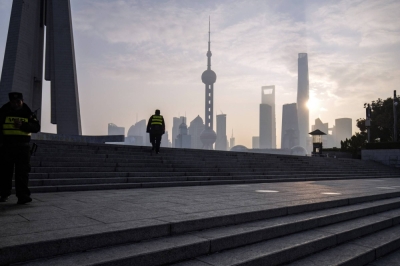 Security guards along the Bund in front of buildings in the Lujiazui Financial District in Shanghai on Tuesday. The pivot away from China may accelerate as positive catalysts are missing at a time when the U.S. Federal Reserve shifts toward monetary easing.