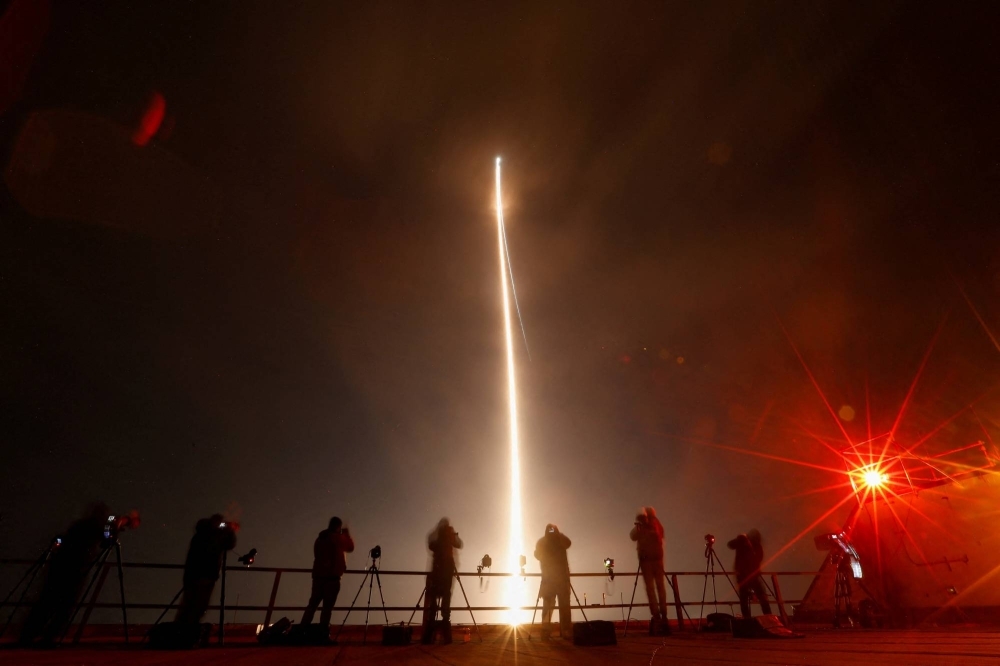 People take photographs during the launch of Boeing-Lockheed joint venture United Launch Alliance's next-generation Vulcan rocket on its debut flight from Cape Canaveral, Florida, on Monday.