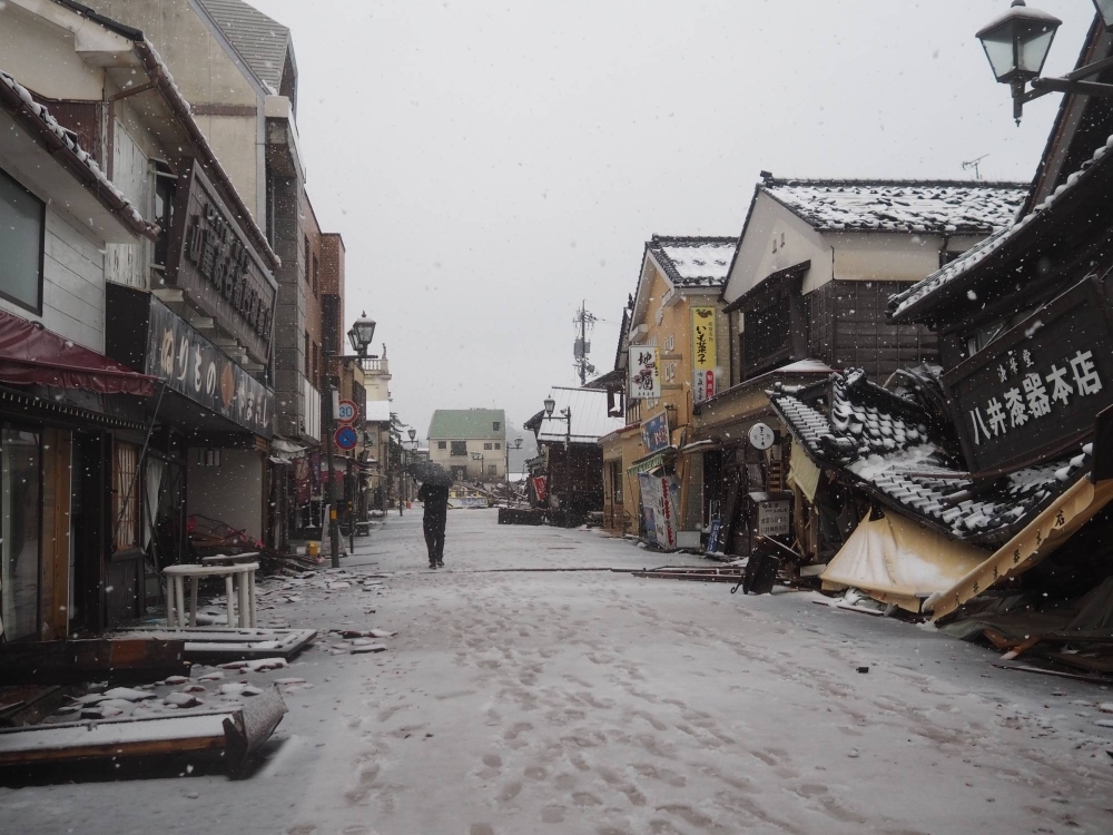 Snow falls on collapsed buildings in the city of Wajima, Ishikawa Prefecture, on Jan. 7, as the area began to look toward recovery from the massive earthquake that struck on Jan. 1.