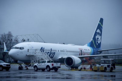 A Boeing 737 Max 9 plane that lost part of its fuselage midair is parked at Portland International Airport in Portland, Oregon, on Monday. The Federal Aviation Administration on Thursday announced it had opened an investigation into whether Boeing failed to ensure that the plane was safe and conformed to the design approved by the agency. 