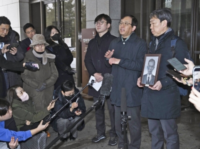 Plaintiffs' lawyers speak to reporters in Seoul on Thursday after South Korea's Supreme Court upheld lower court decisions ordering Nippon Steel to pay damages to South Koreans over wartime labor.