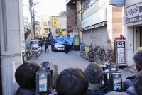 Media reporters gather near a hotel in Tokyo's Taito Ward where a man had holed himself up in a room and taken a woman hostage on Friday morning. | Kyodo