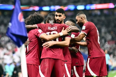 Qatar players celebrate after defeating Lebanon in the opening match of the Asian Cup on Friday in Lusail, Qatar. 